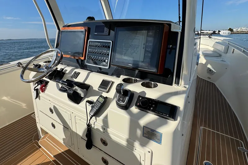 Betsey Ann Yacht Photos Pics 2015 Cobia 344 Center Console boat dashboard with navigation screens and controls.