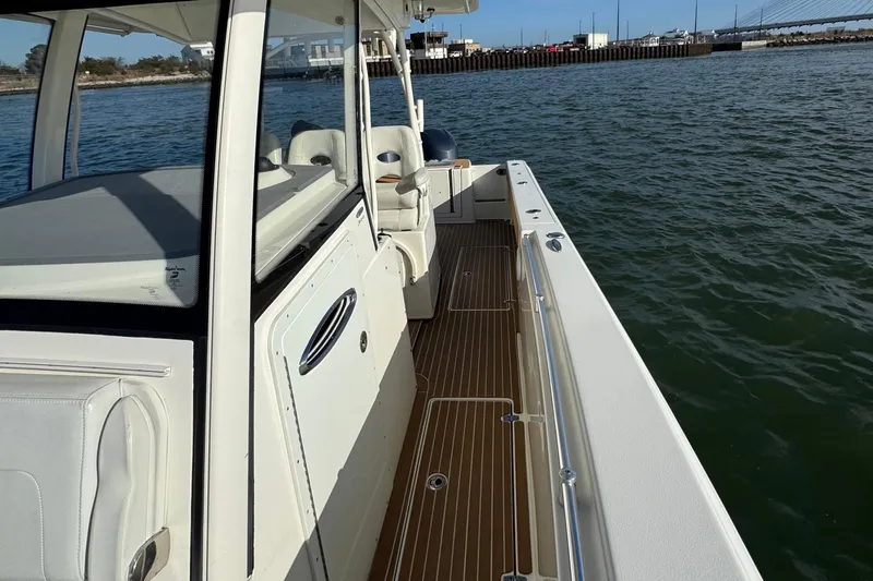Betsey Ann Yacht Photos Pics 2015 Cobia 344 Center Console boat on water, featuring sleek design and spacious deck.