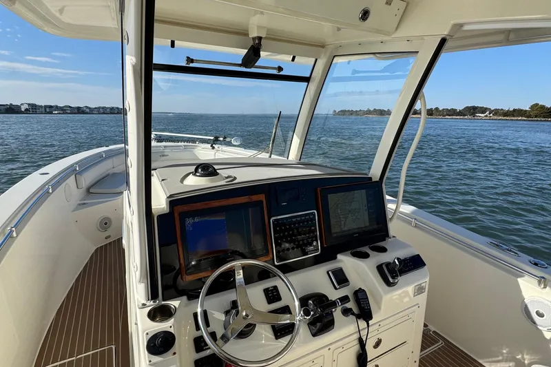 Betsey Ann Yacht Photos Pics 2015 Cobia 344 Center Console boat dashboard with navigation screens on open water.
