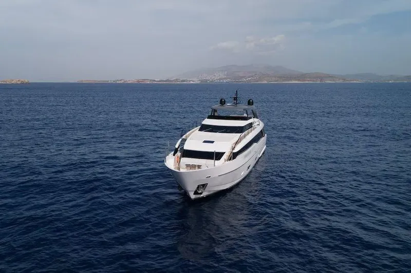  Yacht Photos Pics 2024 Sanlorenzo SL90A yacht cruising on open sea with distant coastline.