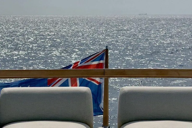  Yacht Photos Pics Sanlorenzo SL90A 2024 yacht deck with ocean view and flag.