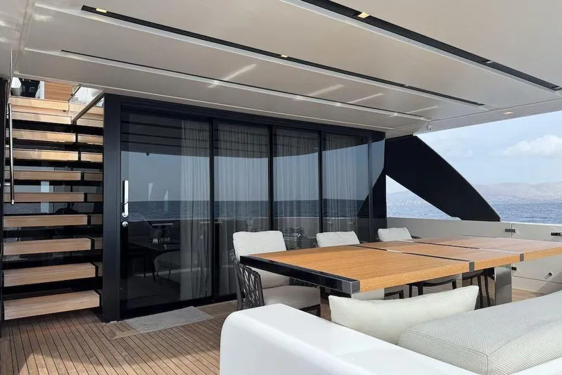  Yacht Photos Pics Luxurious 2024 Sanlorenzo SL90A yacht deck with modern dining area and ocean view.