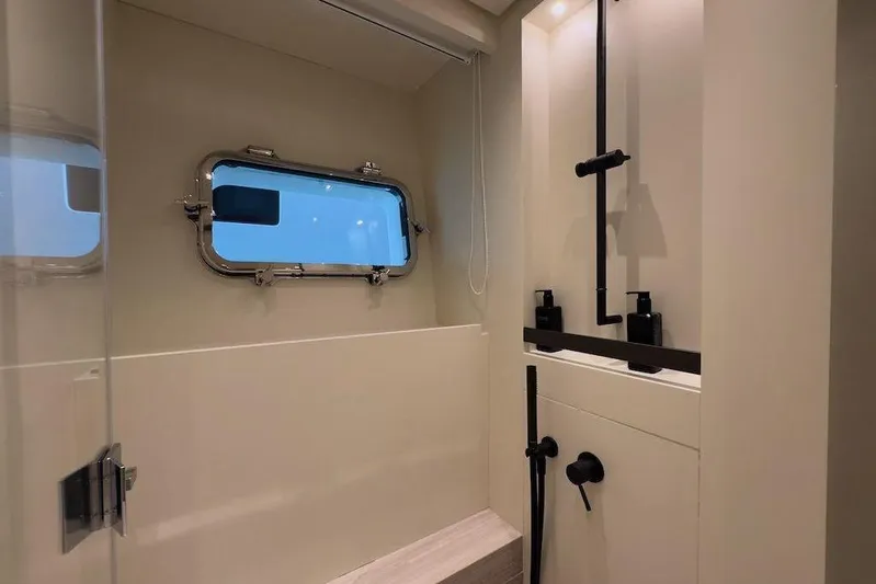  Yacht Photos Pics Modern bathroom interior on 2024 Sanlorenzo SL90A yacht, featuring sleek fixtures and a porthole window.