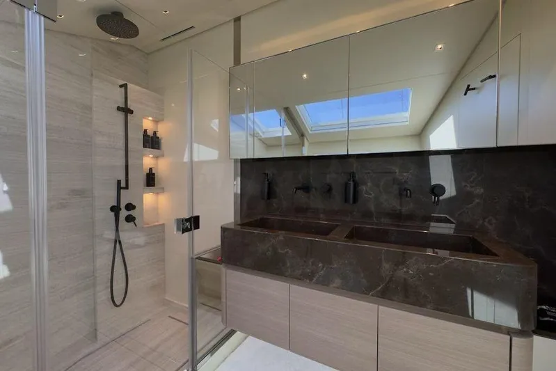  Yacht Photos Pics Luxurious bathroom in 2024 Sanlorenzo SL90A yacht with modern shower and dual sinks.
