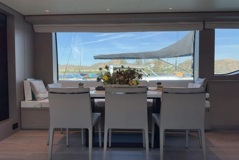  Yacht Photos Pics Luxurious dining area inside 2024 Sanlorenzo SL90A yacht with scenic window view.