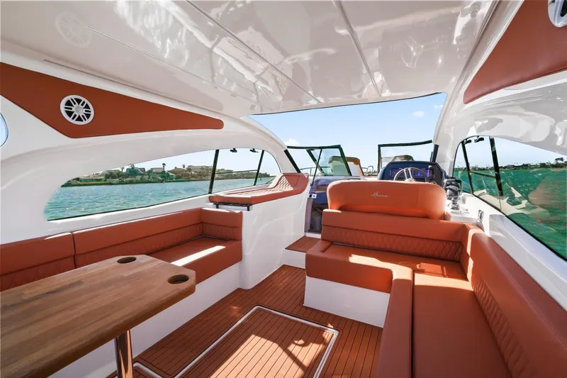 Custom Order Your 355 Today! Yacht Photos Pics Luxurious interior of 2025 Hanover 355 Outboard boat with elegant seating and wood accents.
