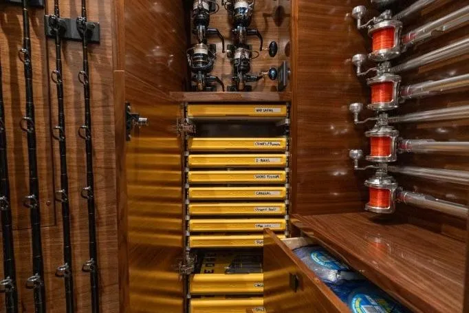 Boujie Yacht Photos Pics Fishing gear storage on 2025 Viking 82 Convertible yacht, featuring rods, reels, and organized tackle boxes.