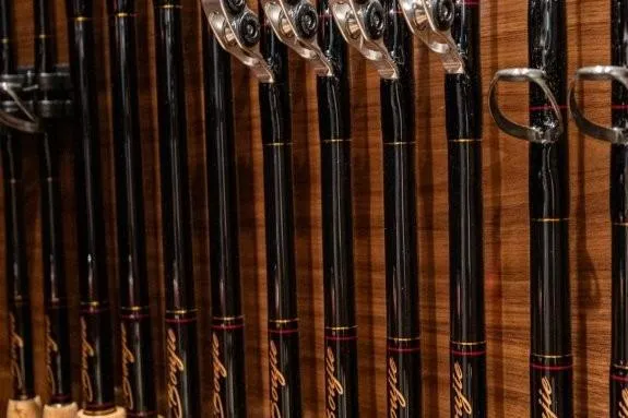 Boujie Yacht Photos Pics Fishing rods neatly arranged on a wooden rack aboard a 2025 Viking 82 Convertible yacht.