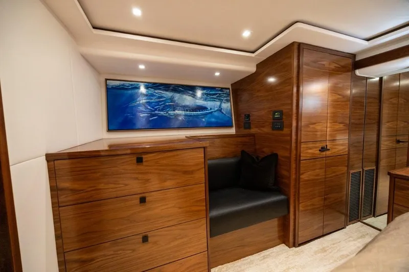 Boujie Yacht Photos Pics Luxurious interior of 2025 Viking 82 Convertible yacht with wood finish and modern lighting.
