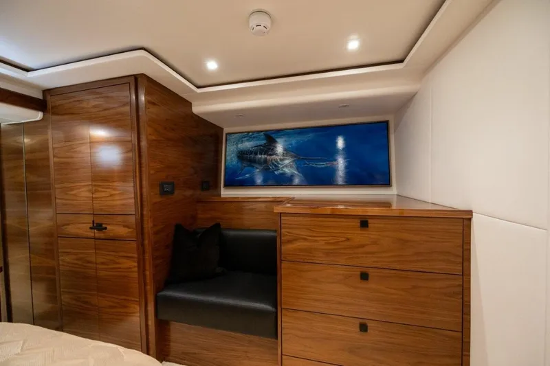 Boujie Yacht Photos Pics Luxurious interior of 2025 Viking 82 Convertible yacht with wood finish and modern decor.