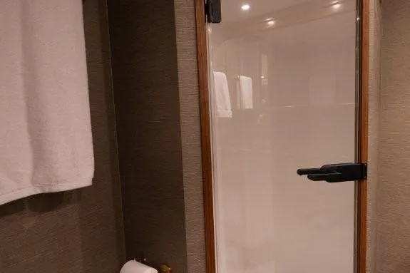 Boujie Yacht Photos Pics Bathroom interior of 2025 Viking 82 Convertible yacht with glass shower door.