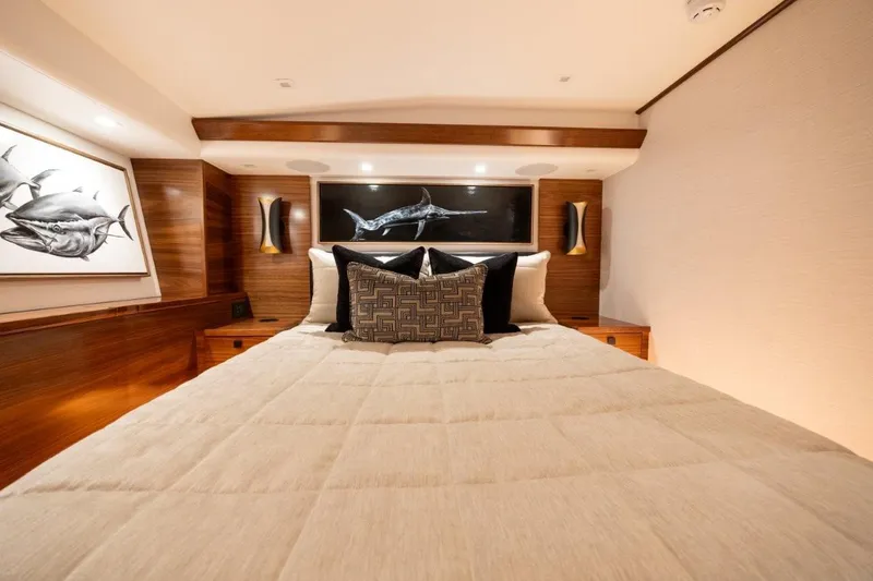Boujie Yacht Photos Pics Luxurious bedroom interior of 2025 Viking 82 Convertible yacht with elegant decor.