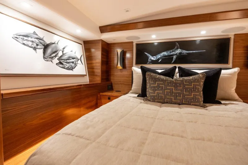 Boujie Yacht Photos Pics Luxurious bedroom interior of 2025 Viking 82 Convertible yacht with marine artwork.