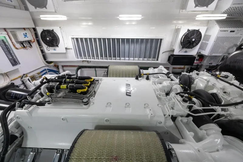 Boujie Yacht Photos Pics Engine room of 2025 Viking 82 Convertible yacht, featuring advanced machinery and ventilation systems.