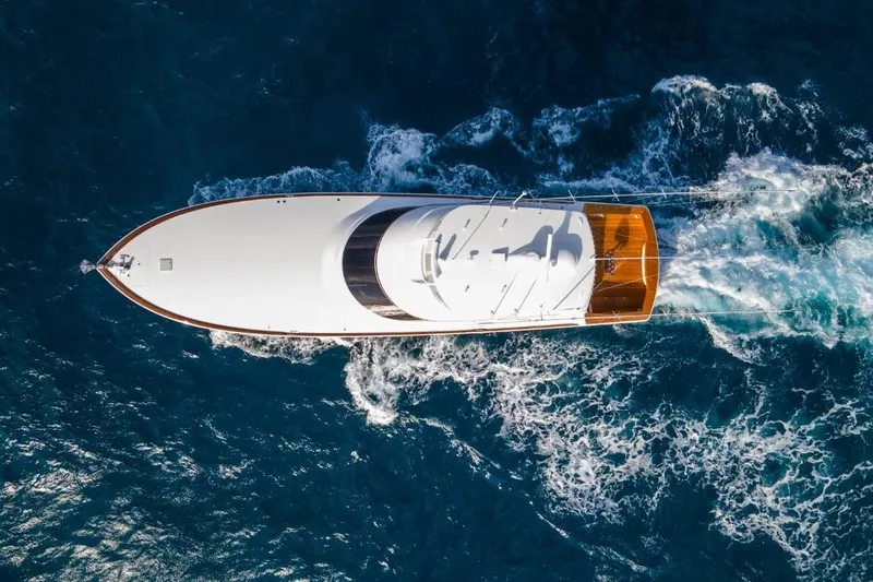 Boujie Yacht Photos Pics Aerial view of 2025 Viking 82 Convertible yacht cruising through blue ocean waters.