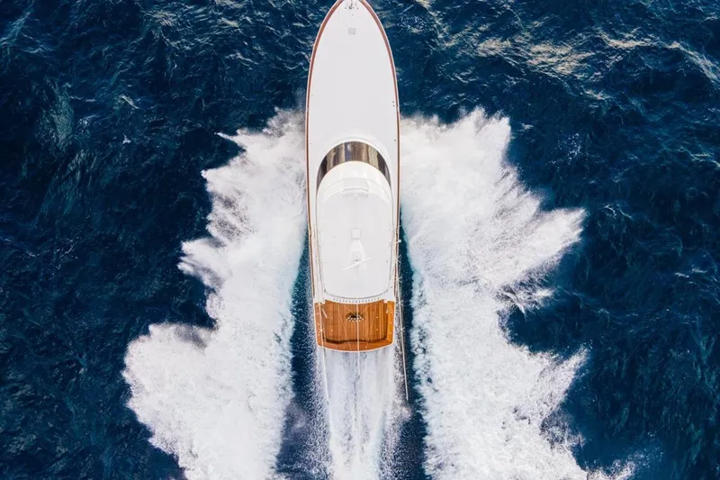 Boujie Yacht Photos Pics Aerial view of 2025 Viking 82 Convertible yacht cruising through ocean waves.