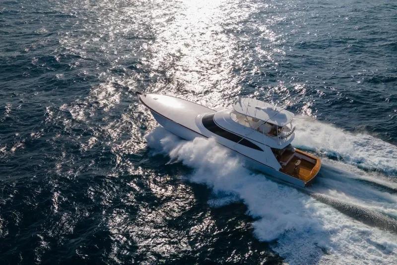 Boujie Yacht Photos Pics 2025 Viking 82 Convertible yacht cruising on open ocean waters.