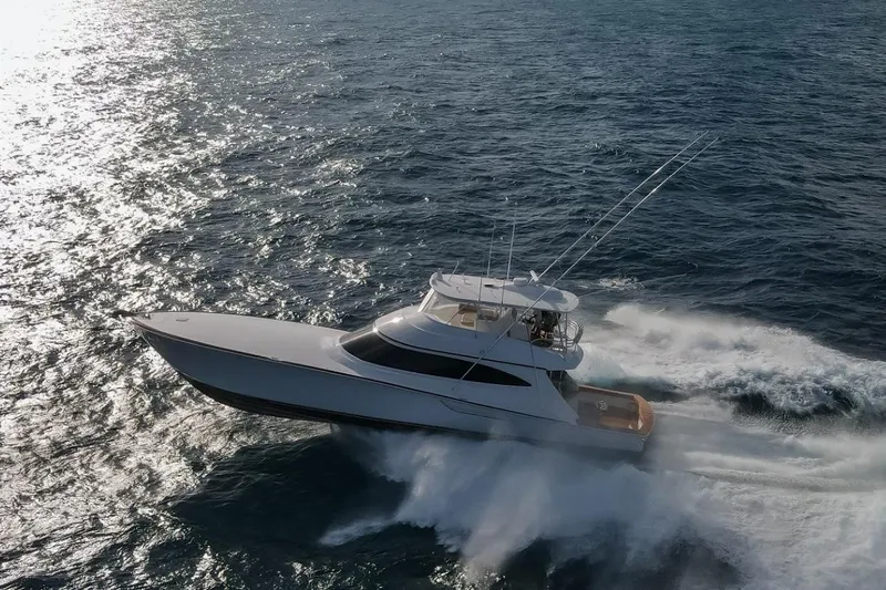 Boujie Yacht Photos Pics 2025 Viking 82 Convertible yacht cruising swiftly on open ocean waters.