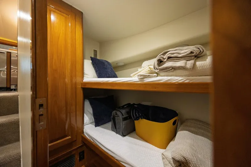 Miss Scarlett Yacht Photos Pics Cozy bunk beds in 1998 Viking 50 Convertible yacht cabin with wooden accents.