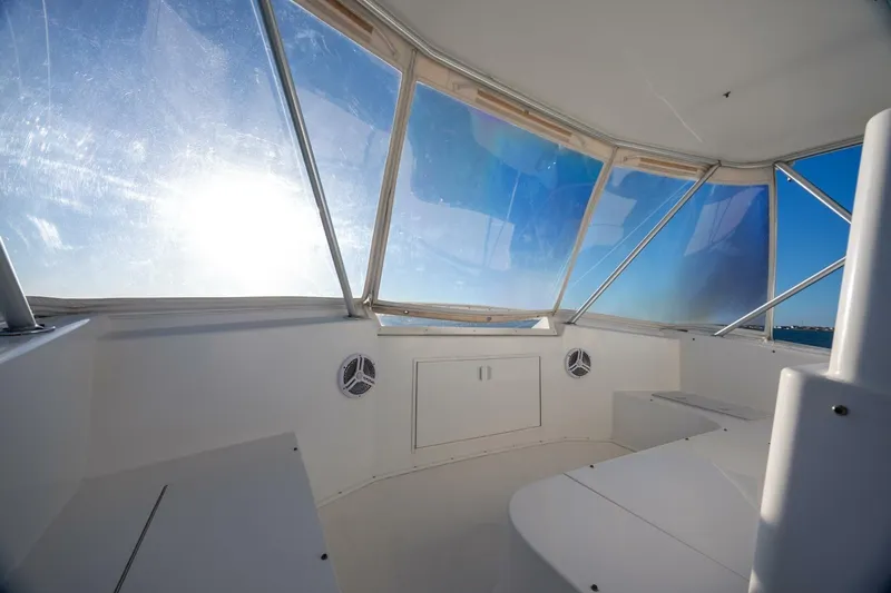 Miss Scarlett Yacht Photos Pics Interior view of 1998 Viking 50 Convertible yacht with sunlit windows and seating.