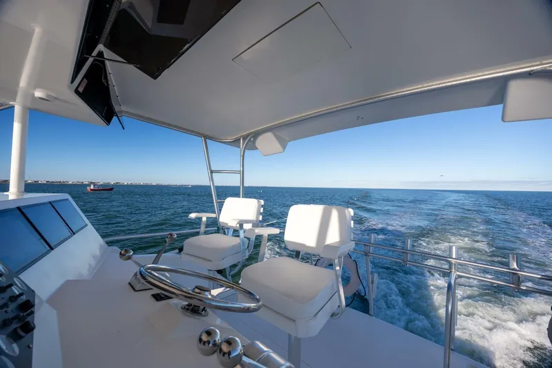 Miss Scarlett Yacht Photos Pics 1998 Viking 50 Convertible yacht helm with ocean view and white seating.