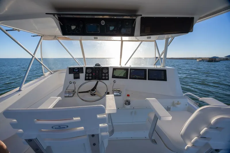 Miss Scarlett Yacht Photos Pics Helm of 1998 Viking 50 Convertible yacht with ocean view and navigational instruments.