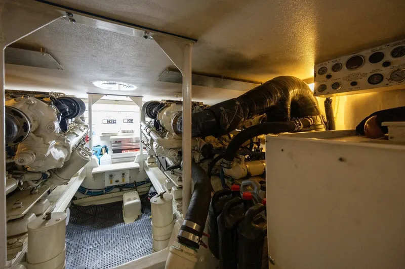 Miss Scarlett Yacht Photos Pics Engine room of a 1998 Viking 50 Convertible yacht, showcasing dual engines and control panels.
