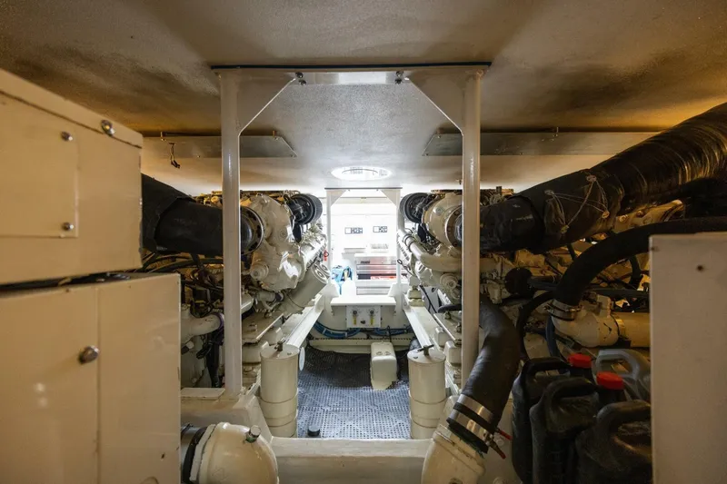 Miss Scarlett Yacht Photos Pics Engine room of a 1998 Viking 50 Convertible yacht, showcasing dual engines and mechanical components.