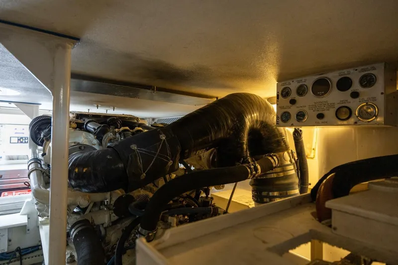 Miss Scarlett Yacht Photos Pics Engine room of a 1998 Viking 50 Convertible yacht, showcasing machinery and control panel.