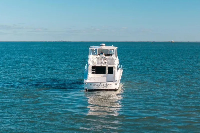 Miss Scarlett Yacht Photos Pics 1998 Viking 50 Convertible yacht cruising on open blue waters.