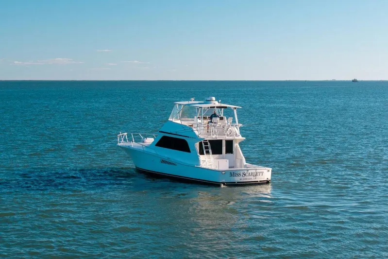 Miss Scarlett Yacht Photos Pics 1998 Viking 50 Convertible yacht cruising on open blue water.