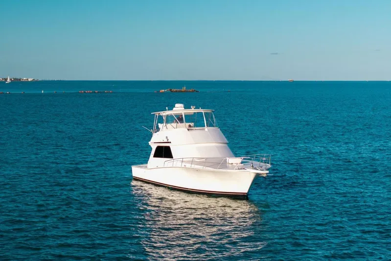 Miss Scarlett Yacht Photos Pics 1998 Viking 50 Convertible yacht on calm blue ocean waters.