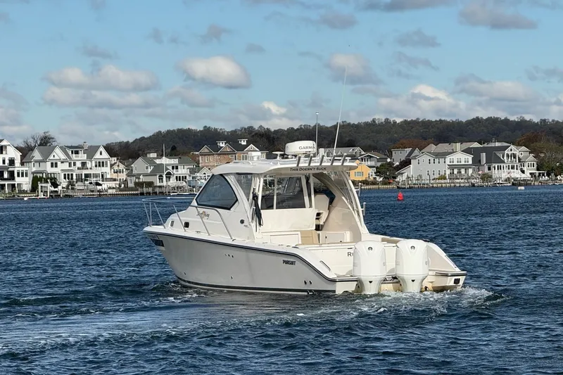  Yacht Photos Pics 2017 Pursuit OS 325 Offshore boat cruising near coastal homes.