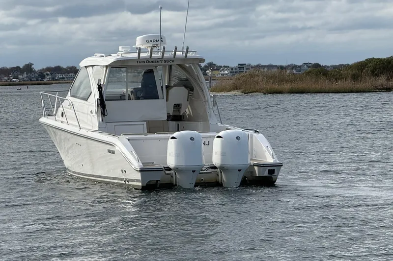  Yacht Photos Pics 2017 Pursuit OS 325 Offshore boat on water with twin engines, overcast sky.