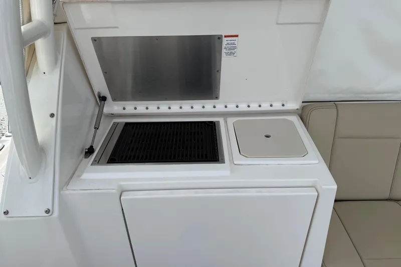  Yacht Photos Pics 2017 Pursuit OS 325 Offshore boat grill and sink area with beige seating.