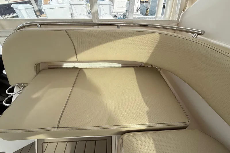  Yacht Photos Pics 2017 Pursuit OS 325 Offshore boat interior with beige cushioned seating.