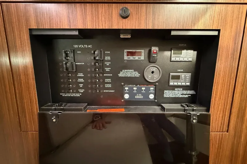  Yacht Photos Pics Control panel of a 2017 Pursuit OS 325 Offshore boat, featuring various switches and displays.