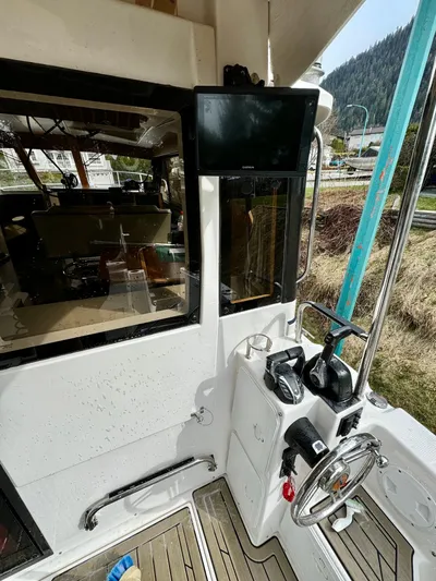  Yacht Photos Pics 2022 Cutwater C32 Northwest Edition boat cockpit with steering wheel and control panel.
