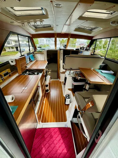  Yacht Photos Pics Interior of 2022 Cutwater C32 Northwest Edition boat with modern wood finishes and seating.