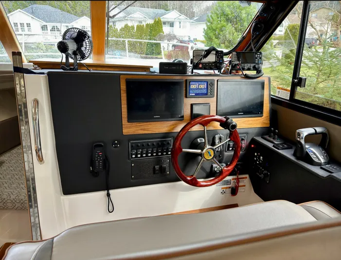  Yacht Photos Pics 2022 Cutwater C32 Northwest Edition helm with dual screens and wooden steering wheel.