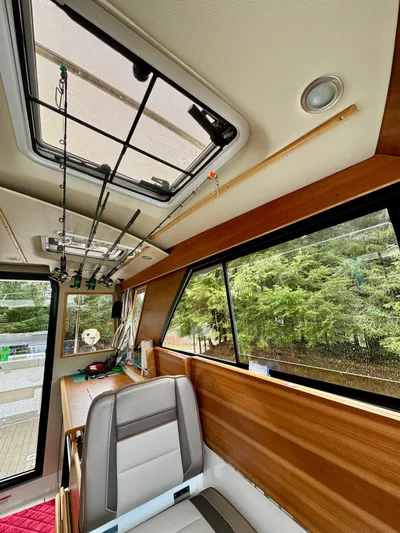  Yacht Photos Pics 2022 Cutwater C32 Northwest Edition interior with fishing rods and large window view.