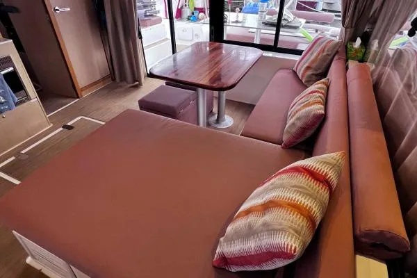 Meraki Yacht Photos Pics Interior of 2022 NEEL 43 with cozy seating and colorful cushions.