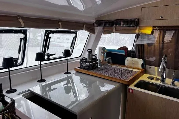 Meraki Yacht Photos Pics Interior of 2022 NEEL 43 yacht kitchen with modern appliances and large windows.