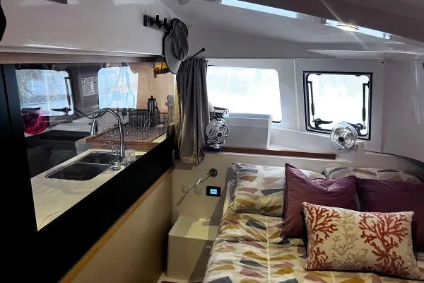 Meraki Yacht Photos Pics Interior of 2022 NEEL 43 yacht with cozy bed, kitchen, and modern amenities.