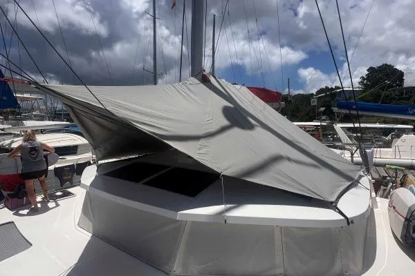 Meraki Yacht Photos Pics Sailing yacht NEEL 43 (2022) with sunshade, docked under cloudy sky.