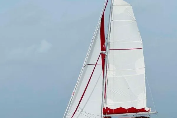 Meraki Yacht Photos Pics Sailing trimaran NEEL 43, 2022 model, with white and red sails on open water.