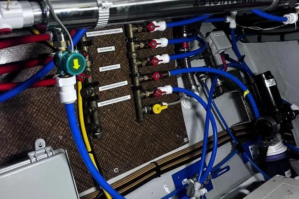 Meraki Yacht Photos Pics Electrical and plumbing system in NEEL 43, 2022 model, featuring organized wiring and labeled valves.
