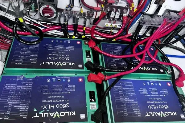 Meraki Yacht Photos Pics Four KiloVault 3600 HLX solar batteries with red cables, NEEL 43 model, 2022.