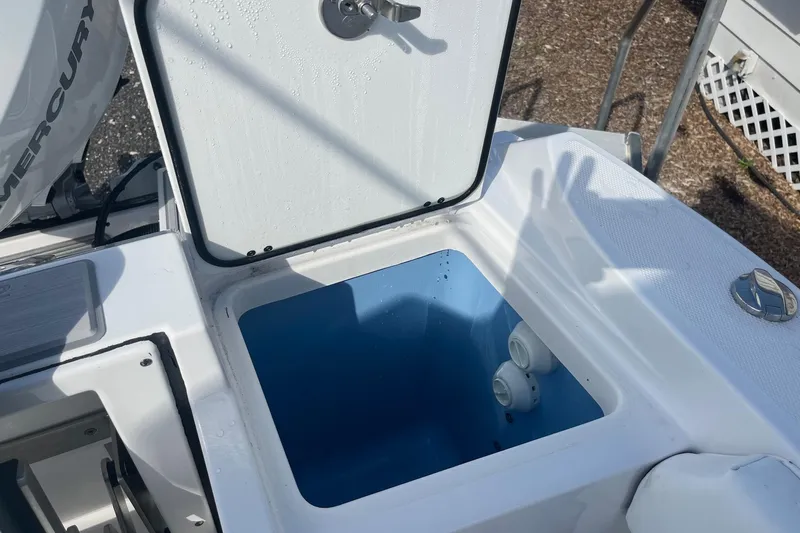  Yacht Photos Pics Open storage compartment on 2025 Blackfin 252 CC boat, featuring a blue interior.