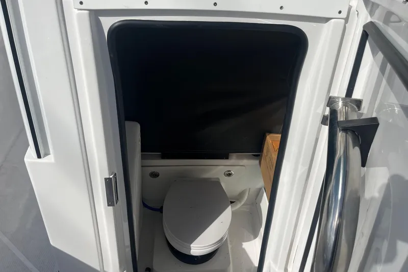  Yacht Photos Pics 2025 Blackfin 252 CC boat interior with compact marine toilet.